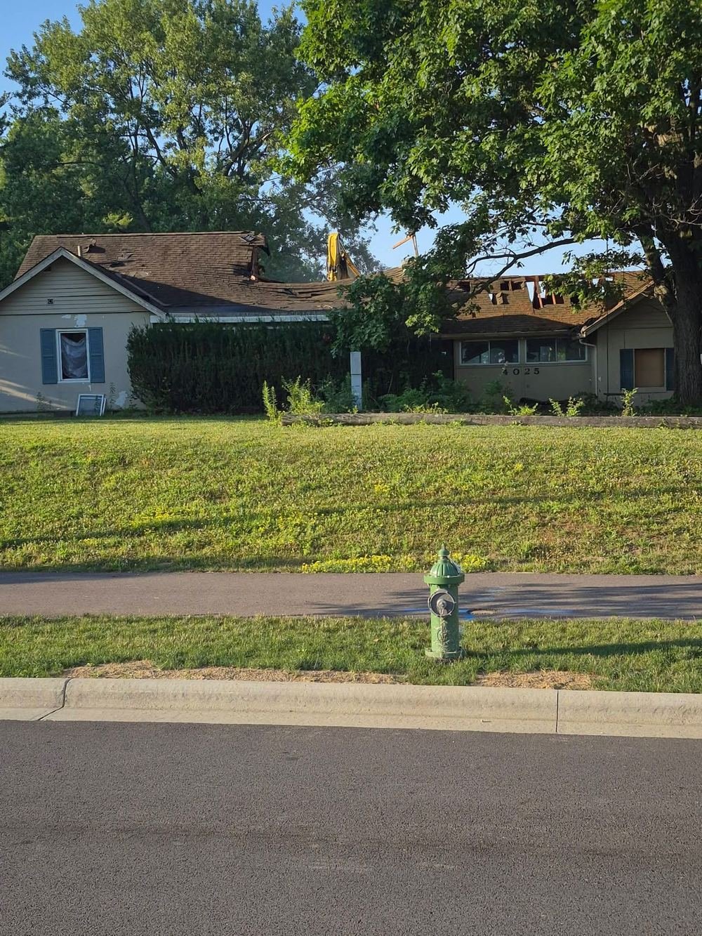 Same house with an excavator arm coming through the roof